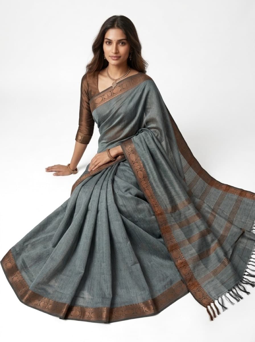 Nilima slate saree on model seated in studio, copper pallu spread