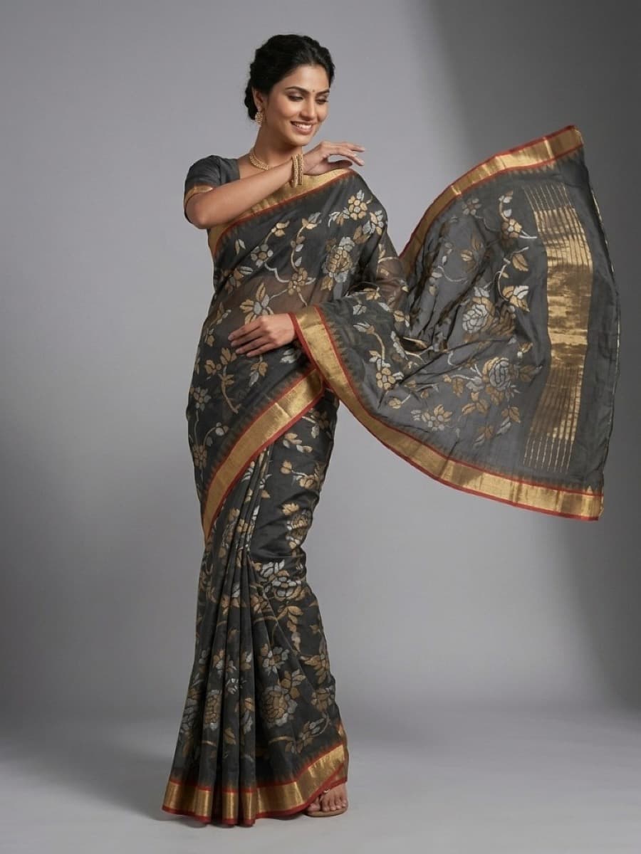 Swarnalata charcoal Jamdani saree in garden light, gold and silver motifs catching sun